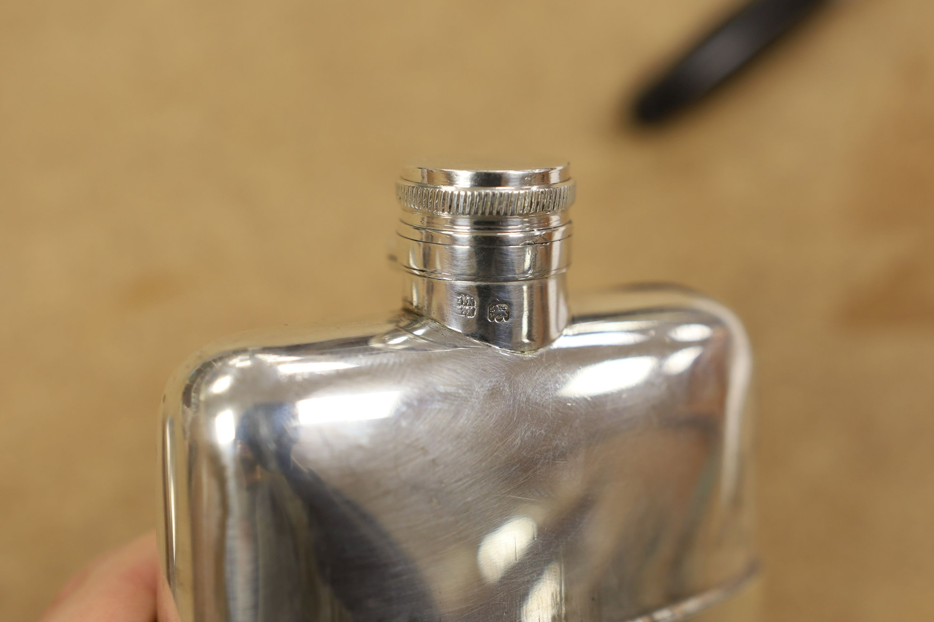 A George V silver hip flask, by Goldsmiths & Silversmiths Co Ltd, London, 1918/19, 13cm, 9oz.